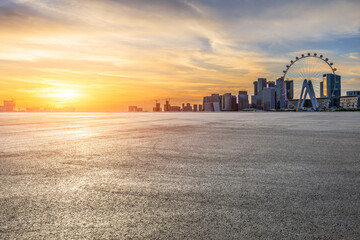 Asphalt road square and modern city buildings scenery at sunset. car advertising background.