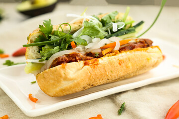Sardine baguette with cucumber, onion, carrot and coriander served in dish isolated table side view of fastfood