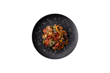 Spicy Asian dish with sliced meat fillet, hot pepper, carrots and sesame seeds