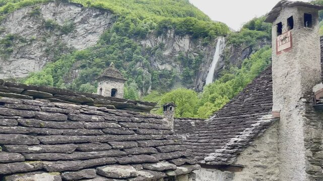 Panoramic view of traditional stone village Foroglio with scenic waterfall in Val Bavona, Vallemaggia, Switzerland.
