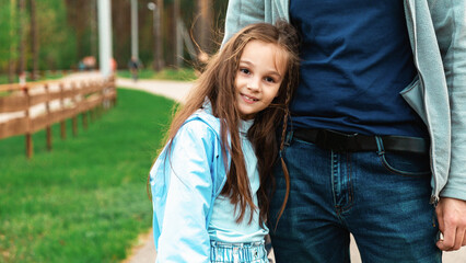 Father and daughter in sunny park. Loving family playing outdoor. Young man and his adorable little girl play and laugh. Happiness and love. Happy fathers day.