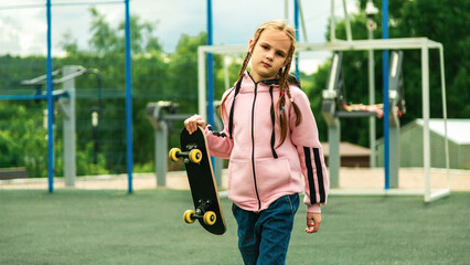 Obraz premium Beautiful hipster girl with skateboard in skate park