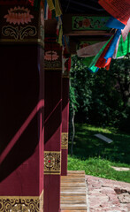 Square wooden columns in a buddhist building. Asian building with red wooden pillars