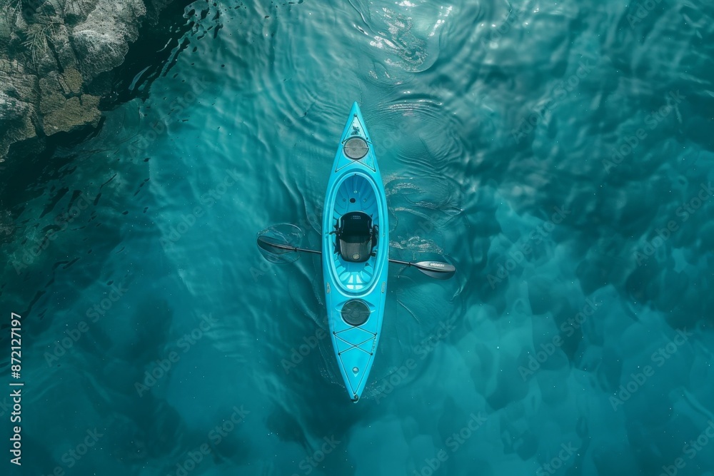 Poster Aerial view of blue kayak floating in crystal clear water