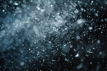 Obraz premium A blurry image of snowflakes falling from the sky