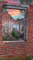 Red brick wall and window in a ruined house.