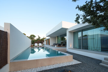 Modern Home with Pool, Designer Features, and Lush Greenery