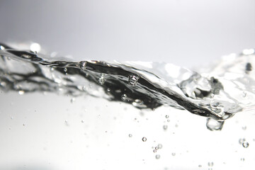 The water surface ripples and contains air bubbles.