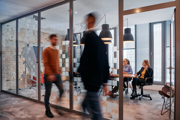 In the dynamic hustle and bustle of a business environment, a group of young business professionals...