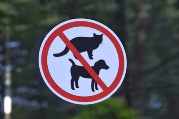 Entry with dogs and cats is prohibited-a sign on the glass door of the building
