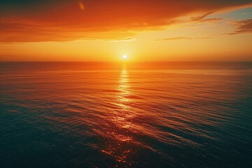 Obraz premium Ethereal Horizon: Sunset Over the Sea Painting the Sky in Shades of Orange