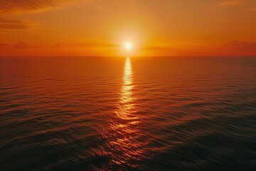 Obraz premium Ethereal Horizon: Sunset Over the Sea Painting the Sky in Shades of Orange