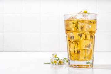 Herbal flower daisy chamomile ice tea, infused aromatic cold drink with daisy camomile wildflower and ice cubes, copy space