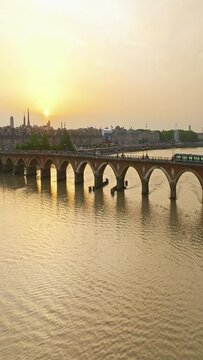 Traffic, Establishing aerial view shot of Bordeaux, world capital of wine, France. A beautiful city on the banks of the river. View from a drone of the city center. Rooftops of houses filmed by drone