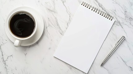 mockup of a blank cover white notepad paper with a cup of coffee and pen on white marble desk background