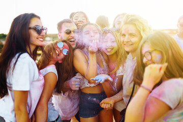 Holi festival. Group of friends having fun at the beach party. Friendship, rest, holidays.