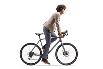 Obraz premium Full length profile shot of a man riding a bicycle standing up