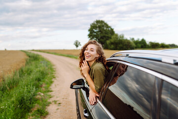 Summer car trip. Beautiful woman on road travel in the car. Lifestyle, travel, tourism, nature, active life.