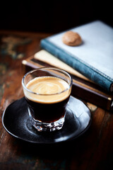 Coffee in glass cup on dark background. Close up. Copy space	