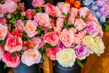 Composition of scarlet light pink roses artificial flowers plastic high quality, imitating natural real camouflage