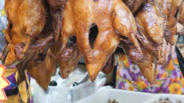 Food stall selling duck at the Old Market of Bangkok's Chinatown during Lunar New Year. People shop for food for Lunar New Year in Thailand. The food preparation is used for offering to ancestors, bri