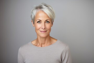 Fototapeta premium Portrait of a beautiful middle-aged woman with short gray hair.