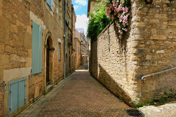 Medieval street in the 11th century fortified village of Belves in the Dordogne, France
