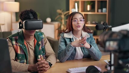 Media, radio and VR headset review with content creator talking product to online audience of followers. Live stream, technology or virtual reality and influencer woman with guest in recording studio