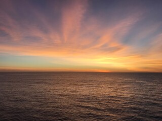 Soft colorful sunset over ocean horizon