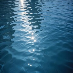 Obraz premium Rippling blue water surface with light reflections