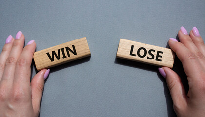 Win or Lose symbol. Concept word Win or Lose on wooden blocks. Businessman hand. Beautiful grey background. Business and Win or Lose concept. Copy space