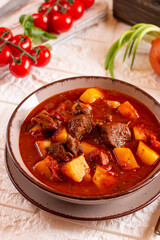 Beef goulash, soup and a stew, made of beef steak, potatoes and plenty of paprika. Hungarian traditional meal, typical Czech food