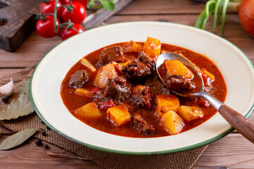 Goulash with potatoes and vegetables seasoned with paprika and other spices. Perfect for recipe, menu book, or any cooking contents. Typical Czech food. Hungarian cuisine.