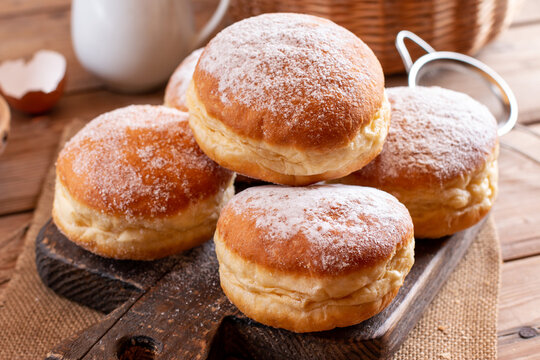Home baked berliner donuts with apricot jam and sprinkled with sugar powder; delicious traditional Slovenian carnival food