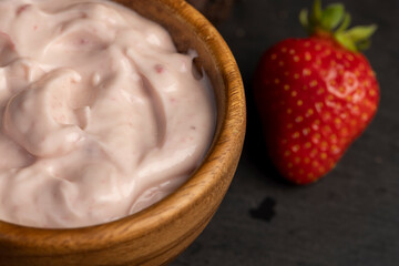 yogurt made from milk with added flavor and pieces of ripe strawberries