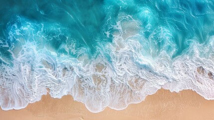 An aerial view of ocean waves gently washing over a sandy shore, showing the beauty of the coastline and the seamless blend of water and land in a serene, natural setting.
