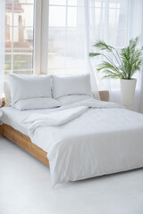 Bed in a bright room. A place to relax.