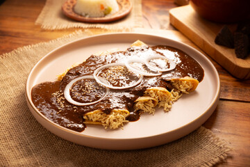Chicken enmoladas. Also known as mole poblano enchiladas, they are a typical Mexican dish that is very popular in Mexico and the rest of the world.