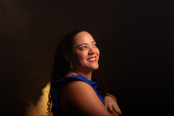 Beautiful woman wearing a blue blouse posing for a photo looking to the left side.