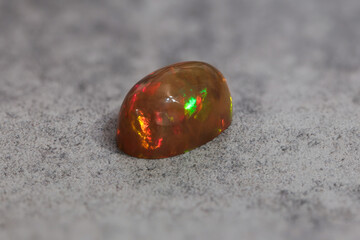 Very-high quality focus bracketing of a Colorful opal gem on grey background