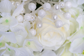Delicate white wedding background with roses and decorations close-up