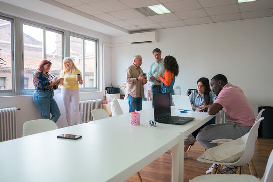 Diverse team engaging in a discussion in a bright office