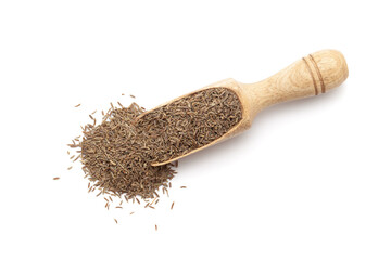 Top view of a wooden scoop filled with Organic Caraway seeds (Carum carvi). Isolated on a white background.