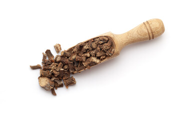 Top view of a wooden scoop filled with dry Organic Gulvel or Giloy (Tinospora cordifolia) herb (Heart-leaved moonseed, guduchi, giloy, crispa). Isolated on a white background.