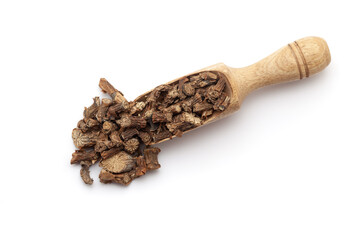Top view of a wooden scoop filled with dry Organic Gulvel or Giloy (Tinospora cordifolia) herb (Heart-leaved moonseed, guduchi, giloy, crispa). Isolated on a white background.