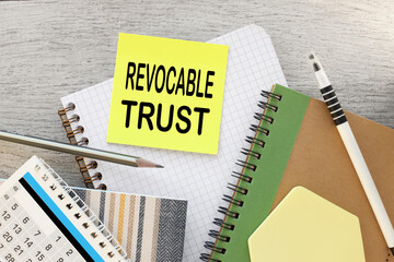Revocable trust yellow sticker with text on the desktop near the calendar