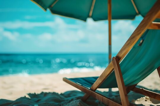 A wooden beach chair and umbrella are set up on a sunny sandy beach, inviting relaxation and enjoyment of the peaceful seaside environment and bright, clear skies.