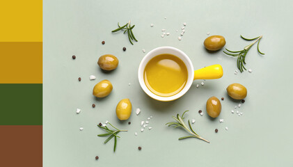 Bowl with fresh olive oil on green background
