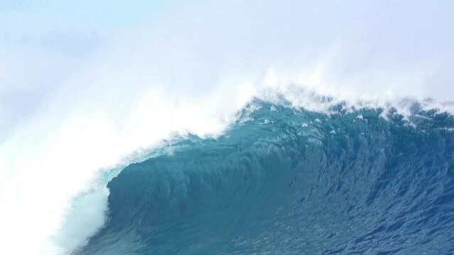 Huge blue ocean wave crashing in slow motion