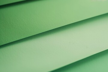 Captivating green material with diagonal lines, modern design, light and shadow play. Ideal for creative projects like banners, posters, websites. Elegance and style for contemporary designs